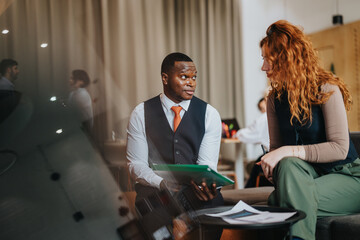 A man and woman engaged in a productive discussion, highlighting teamwork and communication in a...