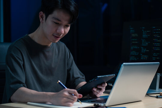 Hacking and malware concept. Hacker using abstract laptop with binary code digital interface.