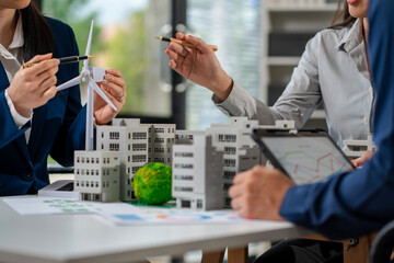 Engineer Teamwork Meeting, with partner on model building at company office working technology, Renewable energy-based green businesses and global warming
