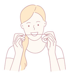 Obraz premium A woman confidently demonstrating the proper dental flossing technique for maintaining healthy oral hygiene