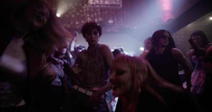 Creative People Move to Energetic Techno Rhythms in a Dark, Color-Drenched Club with Flashing Stroboscopes. Cinematic Footage Celebrating Nightlife, Youth Culture, Freedom and Urban Energy