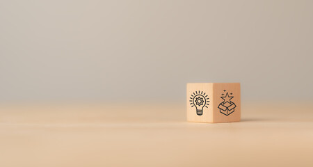 Creative idea generation for new product development concept. Creative thinking and innovation. Wooden block with product development icons, generating creative ideas,  market entry, commercialization