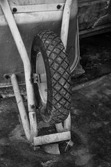 Close-up of an inverted wheelbarrow tire. The wheel has a diamond-shaped tread pattern for...