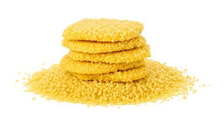 A vibrant stack of golden couscous cakes on a mound of fine couscous grains, showcasing culinary creativity and texture