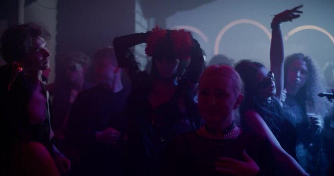 Creative People Move to Energetic Techno Rhythms in a Dark, Color-Filled Club with Flashing Stroboscopes. Cinematic Slow Motion Footage Celebrating Nightlife, Youth Culture, Freedom and Urban Energy