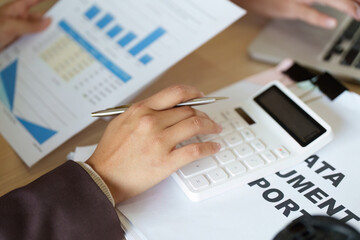 Financial Analysis and Planning. Professional reviewing data with calculator and reports.