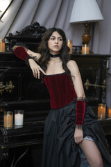 Girl in vintage corset near piano