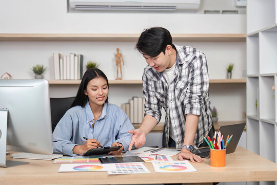Collaborative UX and UI Design Session. Young professionals reviewing digital designs in a creative workspace.