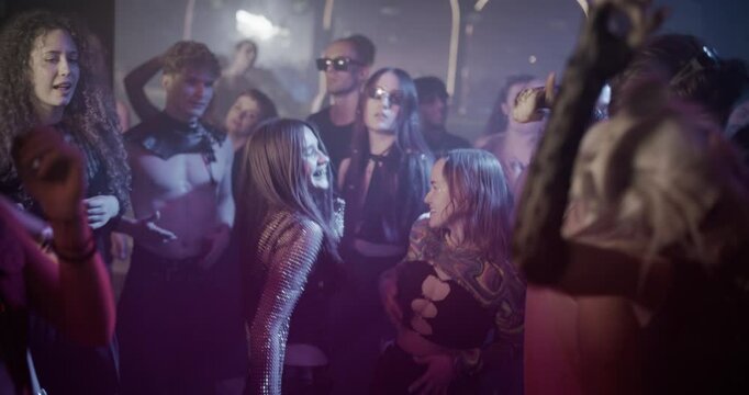 Lovely People Move to Energetic Techno Rhythms in a Dark, Color-Drenched Club with Flashing Stroboscopes. Cinematic Footage Celebrating Nightlife, Youth Culture, Freedom and Urban Energy