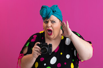 Funny woman in polka dot dress covering ears