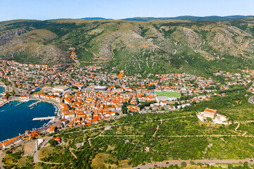 panoramic aerial photo capturing the full layout of Senj, with its historic core, harbor, Nehaj...