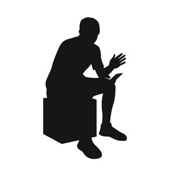Man sitting on pouf, reading on phone, gesturing with hands, black silhouette