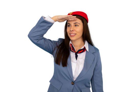 Flight attendant wearing red hat, blue uniform, blocking sunlight and gazing far ahead with professional stance