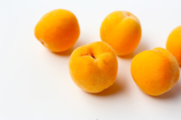 Fresh ripe apricots on a white background.