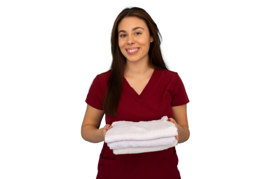 Young woman beautician wearing maroon uniform holding clean white towels, smiling, on transparent background