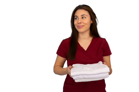 Professional nurse carrying folded white towels, gazing aside with compassionate demeanor against transparent backdrop