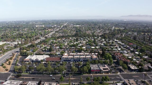 Wide reverse aerial pullback shot of tech-centric Silicon Valley in South Bay, California. 4K