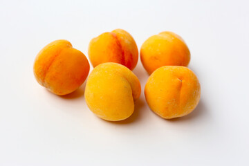 Fresh ripe apricots on a white background.