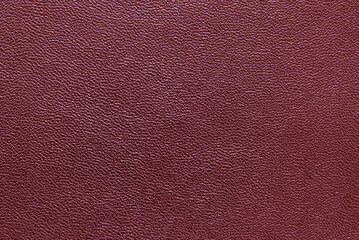 Maroon color grainy fine leather texture as background