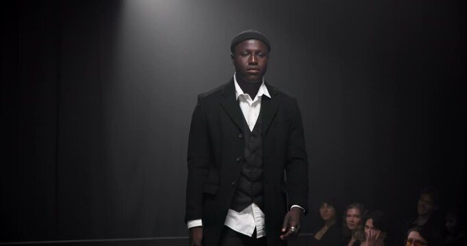 Man, model or runway with dress for fashion show, garment collection or designer brand. Male person, crowd or audience with clothing line or outfit for style publicity or fashionable trend on walkway