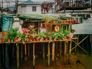 Traditional Stilt Houses In Hong Kong Village: Colorful Weathered Structures Built On Wooden...