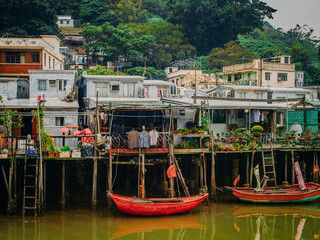 Traditional Stilt Houses In Hong Kong Village: Colorful Weathered Structures Built On Wooden...