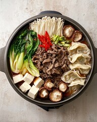 Korean Hot Pot with Beef, Dumplings, Mushrooms and Vegetables &ndash; Overhead View