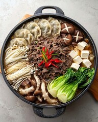 Korean Hot Pot with Beef, Dumplings, Mushrooms and Vegetables &ndash; Overhead View