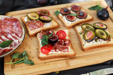 Toasted white bread with labneh, prosciutto, salami, figs, cherry tomatoes, basil, pumpkin seeds....