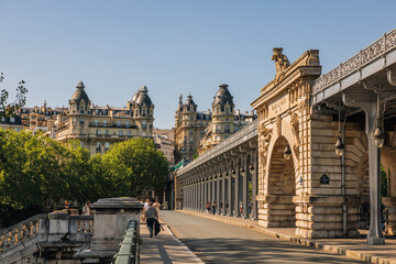 Fototapeta premium People walking along the historic Pont de Bir-Hakeim, a famous bridge in Paris, France.