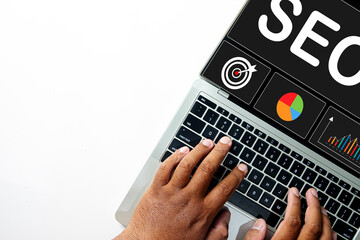 Top view of hands typing on a laptop with an SEO dashboard on screen. Concept for Search Engine Optimization strategy, data analysis, keyword research, and improving website ranking.