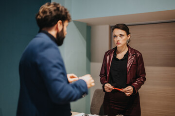 A professional meeting between two colleagues in an office setting, emphasizing communication and...
