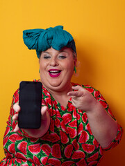 Plus size woman pointing at smartphone with excitement