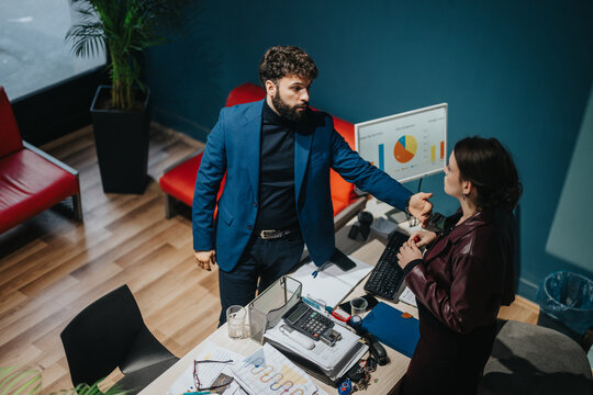 Business professionals collaborate on project analysis, reviewing charts and documents in a stylish office setting.