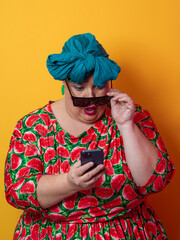 Surprised plus-size woman looking at smartphone with wide expression