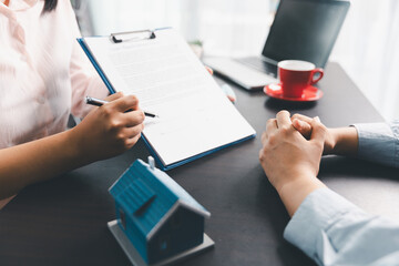 Woman real estate sale agent, client after signing agreement contract real estate with approved mortgage application form concerning mortgage loan offer, house insurance. contract agreement in office