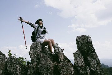 Woman hiker on top of mountain. Hiker with arms up on top of mountain successful young woman...