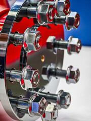 Close-up view of a shiny, silver mechanical component showcasing precision bolts and nuts in a workshop setting