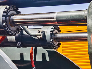 Hydraulic machinery components in a construction site during bright daylight