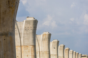 Abstract Perspective of Elevated Concrete Railway Pillars Against Sky