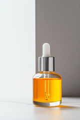A sleek amber dropper bottle with a silver cap, showcasing a minimalist design and pure oil, emphasizing elegance.