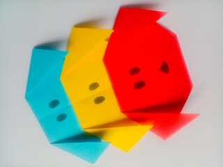 Origami blue, yellow, and red dog head isolated on white background.