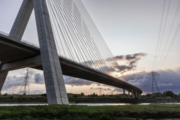 Fototapeta premium Flintshire Bridge stands prominently in the soft light of early morning, with its cables and concrete structure leading into the distance