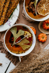 Cozy autumn vibes with herbal tea, homemade bread, dried citrus slices, and seasonal decor – a perfect setting for relaxation and warmth.