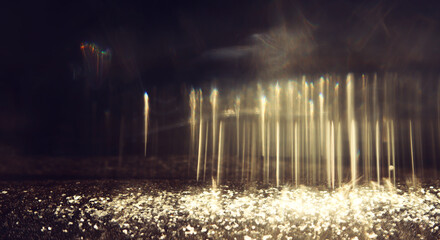 abstract glitter gold and black lights background. de-focused