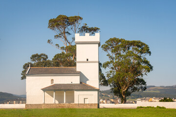 Chapel surrounded by lush greenery in Ribadeo Spain offers serene views in clear weather