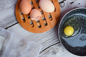 Making breakfast - frying eggs in the small pan.