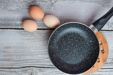 Making breakfast - frying eggs in the small pan.