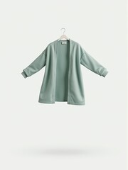 A minimalist style, light green cardigan is presented on a hanger against a neutral background.