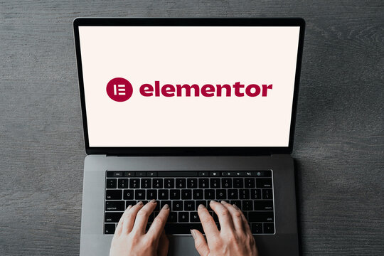 Web designer working on elementor website builder using laptop computer